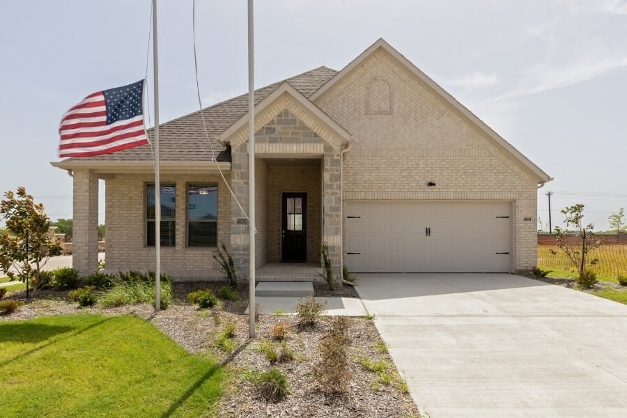 Single-story suburban house with an american flag on display.